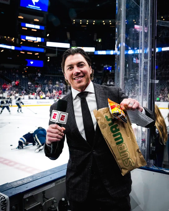 T.J. Oshie holds up an order of Subway and Flamin' Hot Cheetos before interviewing Alex Ovechkin. 