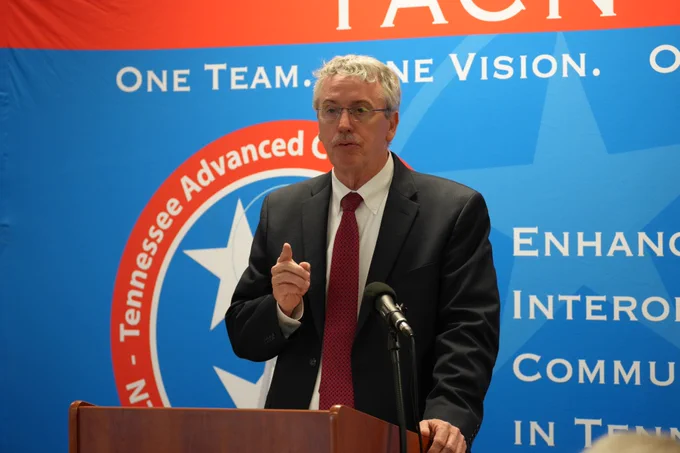 Dickson County Mayor Bob Rial speaking at a podium in front of the TACN backdrop.