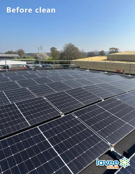 Commercial rooftop solar panels before cleaning, with visible surface soiling across the full array.