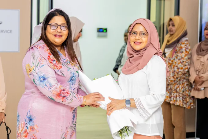 Minister Geela Ali and Permanent Secretary Waleedha. 
Permanent secretary is greeting Minister with a bouquet