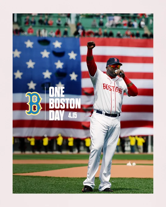 TEXT:
ONE BOSTON DAY
4.15

IMAGE: Photo of David Ortiz from 2013 shows him with his fist in the air, speaking into a microphone just in front of the mound at Fenway Park. The American flag is draped over the Monster and Ortiz wears a white uniform that reads “Boston” across the chest.