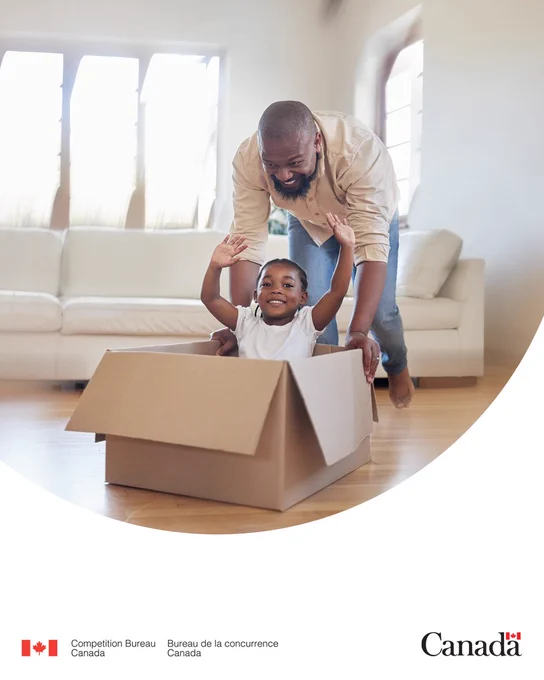 Cheerful father playfully pushing his happy child around a living room in a cardboard box.