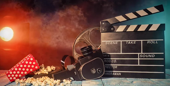 The clapperboard is ready, the production lights are on. Popcorn is scattered on the floor, and the movie is about to begin.