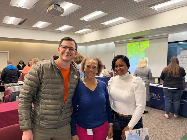 Three employees at the wellness fair