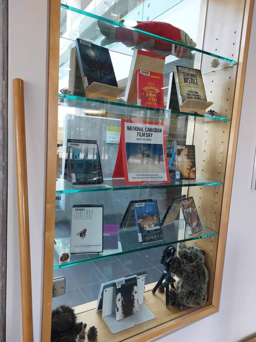 Display case filled with movies, trail camera and puppets