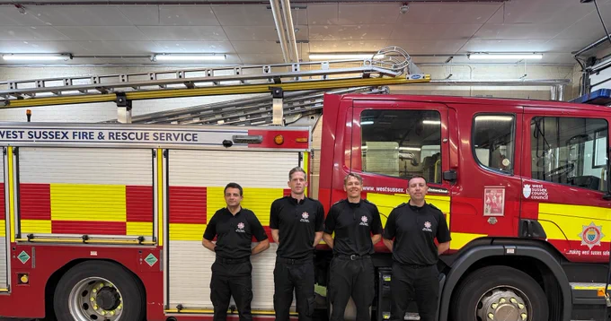 East Grinstead firefighters standing in front of a fire engine