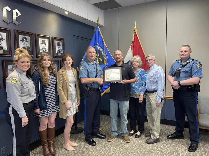 Photo of Capt. Jinkens presenting Honorary Trooper certificate to Mr. Eagan.