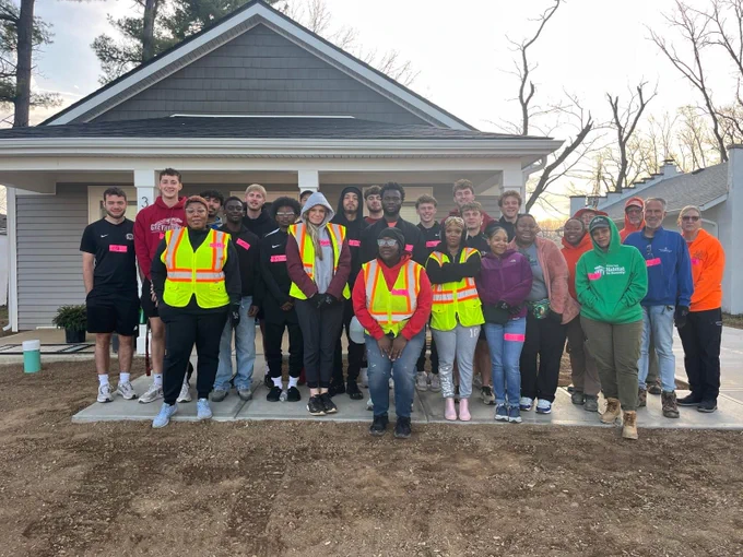 Picture of university of Indianapolis men’s soccer team landscaping with Habitat for Humanity.