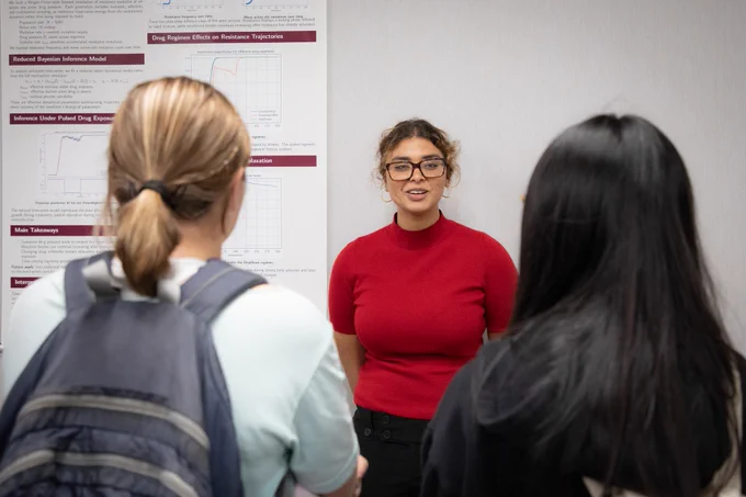 A student presents her research poster at the 2026 Computational Exposition event.