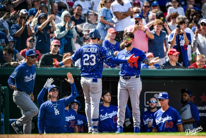 A photo of Andy Pages throwing sunflower seeds at Kyle Tucker in front of the dugout after hitting a home run.