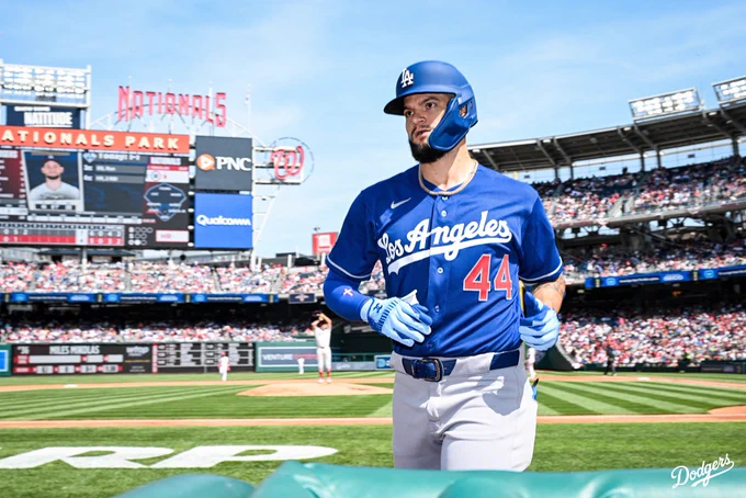 A photo of Andy Pages running towards the dugout after hitting a home run.