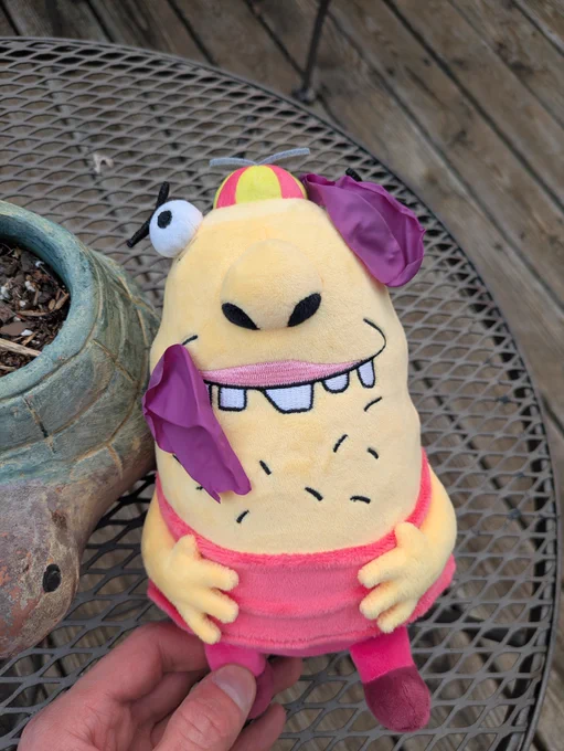 Pieces of the bubble gum (The balloon) are resting on the Beans plush's face.