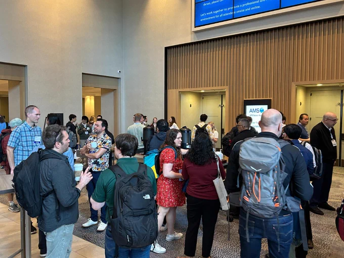 Attendees networking during coffee break.