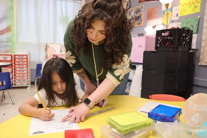 Ms. West helps a student at LBJ