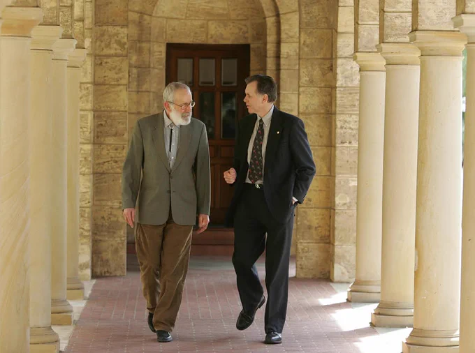 Robin Warren and Barry Marshall walk to a press conference at the University of Australia, 4 October 2005, after being awarded the Nobel Prize.