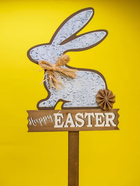 Decorative Easter bunny sign with 'Happy Easter' text and rustic embellishments on a bright yellow backdrop.