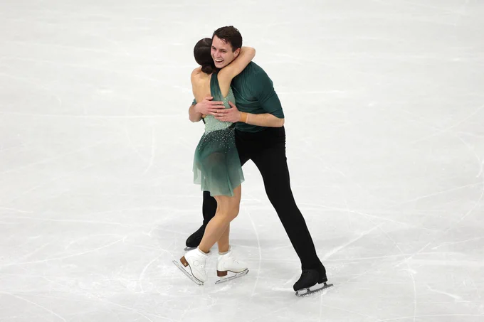 Luke hugging Ana on the ice
