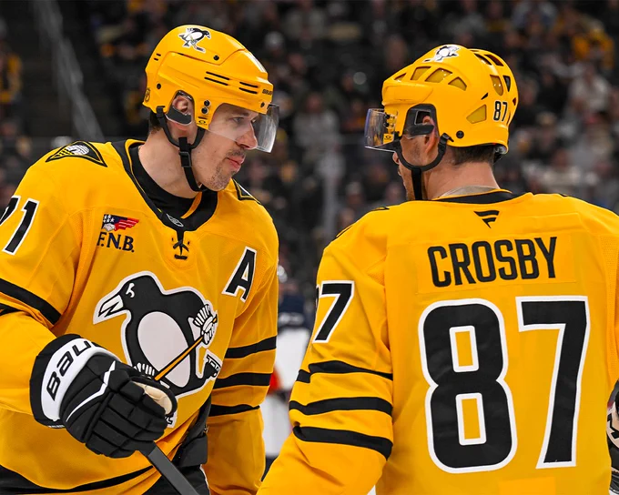 Evgeni Malkin and Sidney Crosby on ice in Penguins uniforms. 