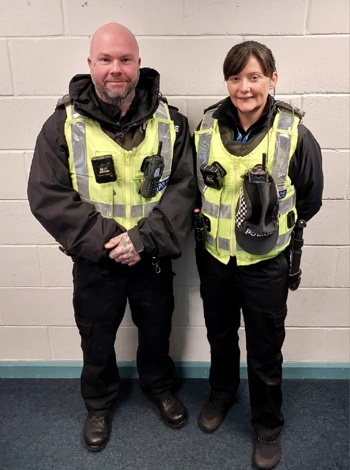 A male and female officers in full uniform