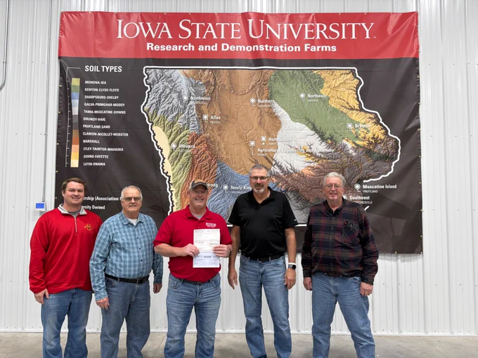 North Central Iowa Research Association Board members receive a donation check from Randy Yeakel with Comm1 Network Inc in support of the new building at the Northern Research Farm.  