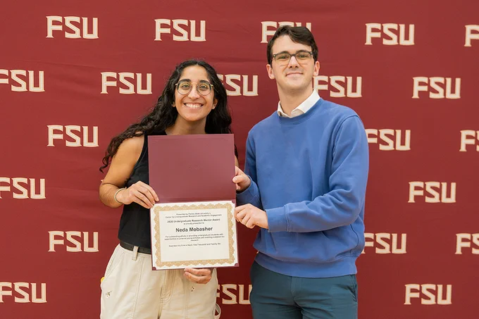Photo of doctoral student Neda Mobasher receiving an Undergraduate Research Mentor Award.