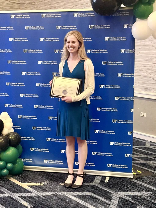 Elizabeth Hansen holding her award certificate.