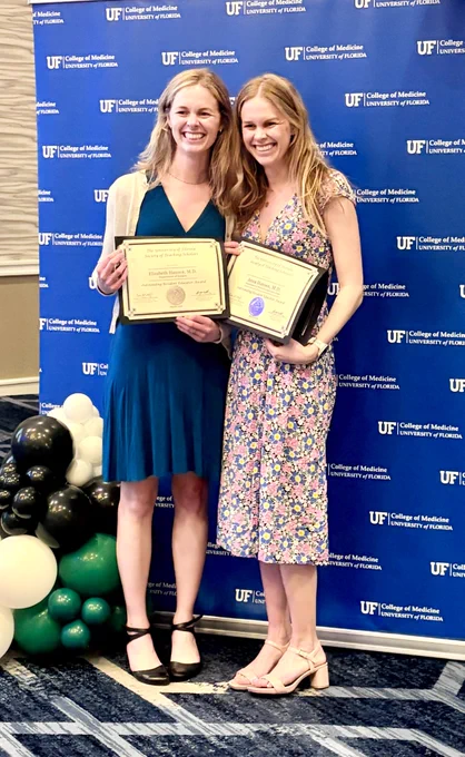 Elizabeth Hansen and her sister, Ana, both holding their awards.