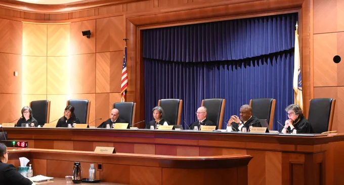 Photo of seven judges sitting in a line in a courtroom.