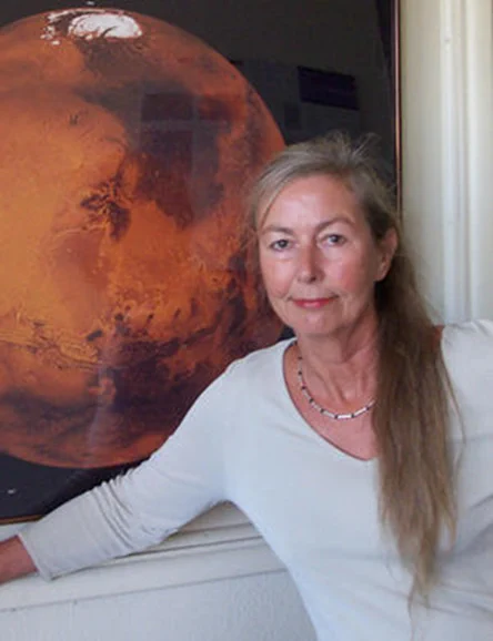 Astrogeology scientist Baerbel Lucchitta in front of an image of Mars