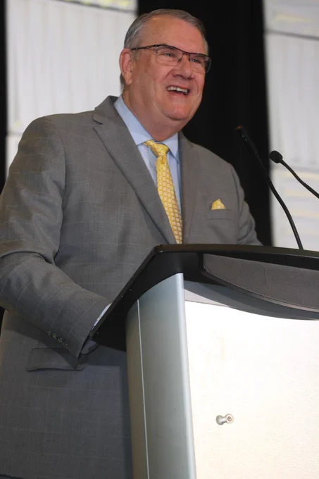 Doug Steele smiling at a podium