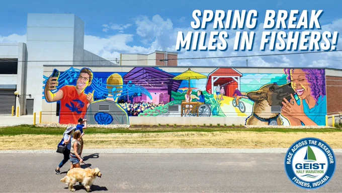 This image shows a colorful mural on a large wall. The mural includes vibrant depictions of people engaged in various activities like taking photos and drinking. Above the mural, large text reads, "Spring Break Miles in Fishers!" In the foreground, a person is walking a dog. A logo at the bottom right corner reads, "Geist Half Marathon, Fishers, Indiana."