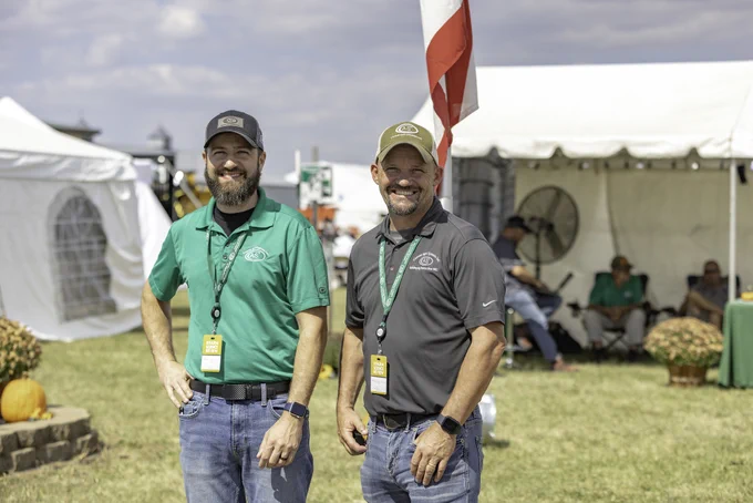 Exhibitors from Custom Agri Systems smile for the camera at Farm Science Review.