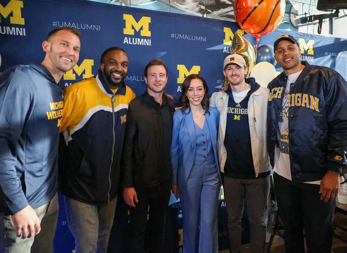 Nik Stauskas, Corey Person, Spike Albrecht, Nicole Auerbach, Stuart Douglass, and Jordan Morgan pose for a photo at the Alumni Territory Men's National Championship Tailgate.