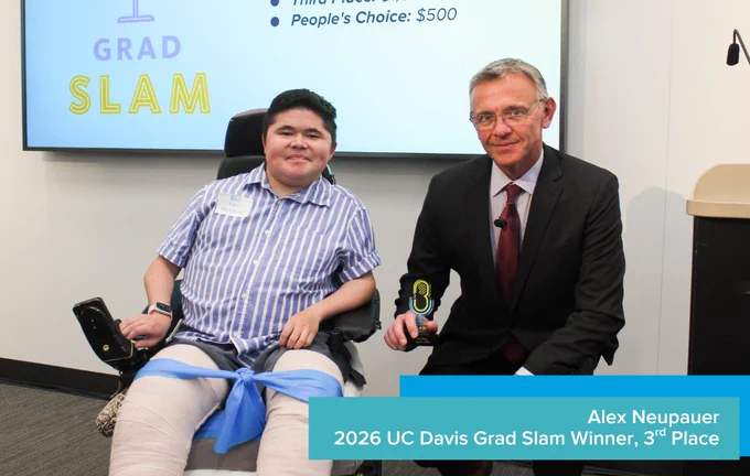 3rd place winner Alex Neupauer smiling and holding a trophy next to Dean Jean-Pierre Delplanque.
