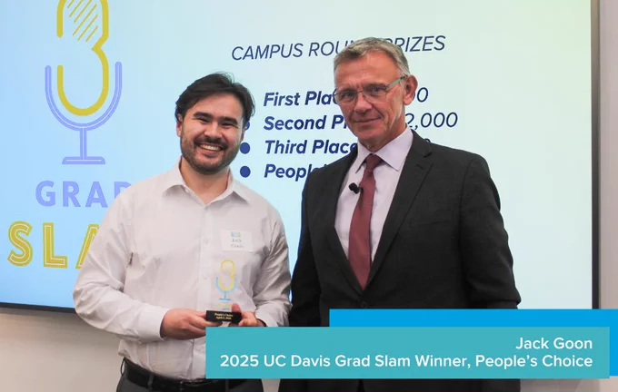 People's choice winner Jack Goon smiling and holding a trophy next to Dean Jean-Pierre Delplanque.