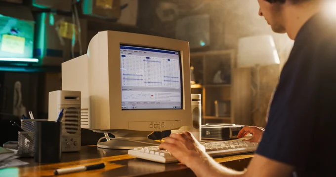 An office worker uses an old business system on an old computer