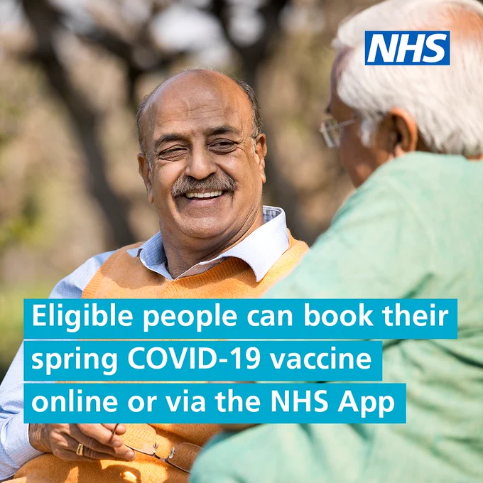 Two elderly men talking outdoors with NHS logo promoting spring COVID-19 vaccine booking online or via NHS App. Text reads 'Eligible people can book their spring COVID-19 vaccine online or via the NHS App'.