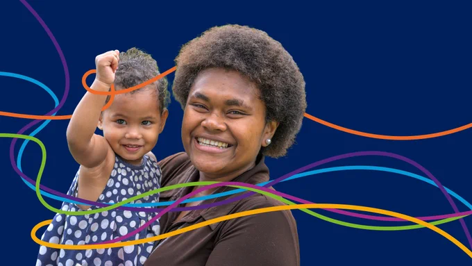A smiling woman holds a young child who is raising their fist playfully. Both are looking toward the camera against a dark blue background with colorful, wavy lines flowing across the image.
