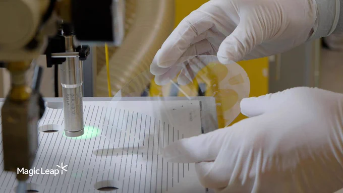 A Magic Leap technician holds an etched waveguide wafer during a customized metrology process.