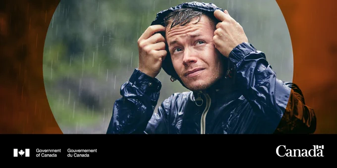 Someone pulls over their hood in the rain.