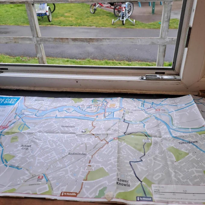A photo of a cycle map on a desk in front of an open window showing cycle routes through Bedminster and south Bristol.