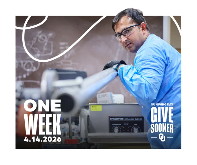 A person in safety goggles and a blue lab coat works in a laboratory. The background has a chalkboard and equipment. Text reads "ONE WEEK 4.14.2026" and "OU GIVING DAY GIVE SOONER" with the University of Oklahoma logo.