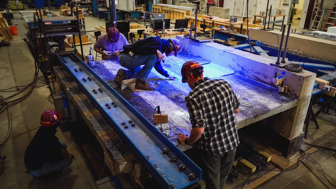 Research and work done by students and faculty members in the Charles E. Via, Jr. Department of Civil and Environmental Engineering, seen here testing the strength of reinforced concrete diaphragms, are one of many reasons why the College of Engineering has a strong reputation both nationally and globally. 