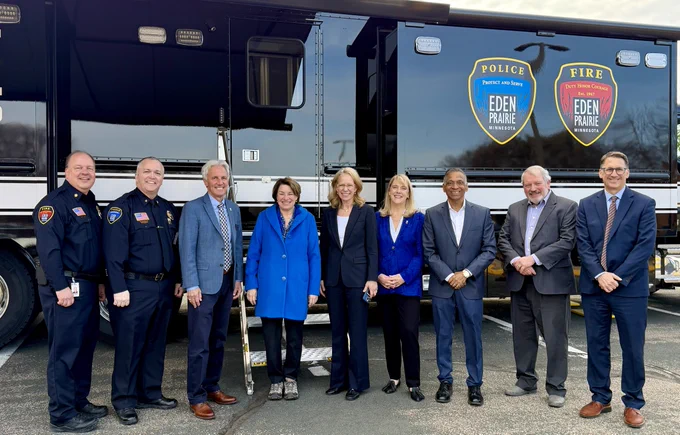 Sen. Amy Klobuchar and Rep. Kelly Morrison pose with Eden Prairie Mayor Ron Case, Council Members Lisa Toomey, PG Narayanan and Mark Freiberg, along with City Manager Rick Getschow, Fire Chief Scott Gerber and Police Chief Matt Sackett in front of Eden Prairie's new Mobile Command Center