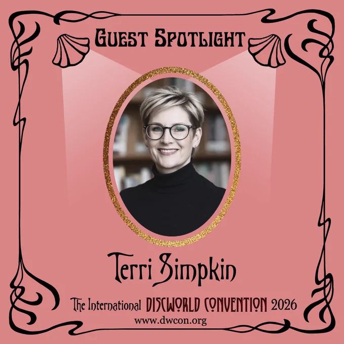 Pale red square background with black art nouveau border and text reading "Guest Spotlight".  Below it sitting in a golden glitter frame, lit by two opera clam shell lights is a photo of Terri Simpkin.  At the bottom is written "Terri Simpkin"