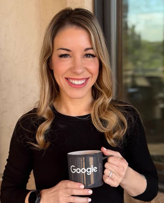 Sarah smiling and holding a Google mug