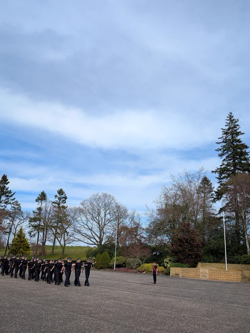 Police officers marching on the parade square during a drill lesson.