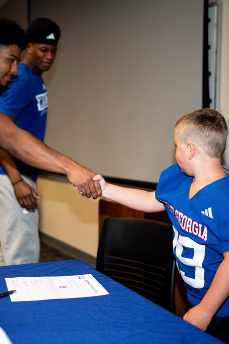Maddox shaking hands with another football player