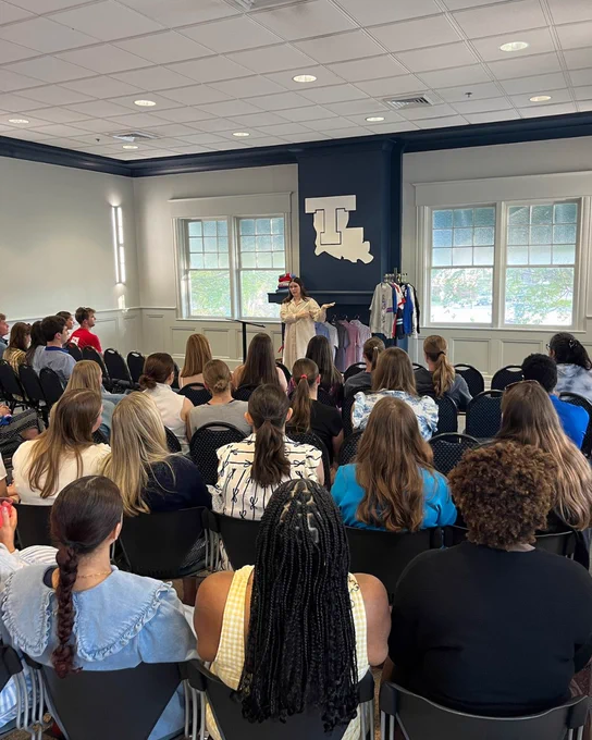Mallory Patterson standing while speaking to students in the audience