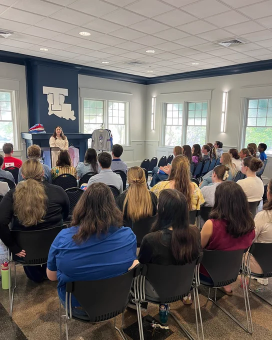Mallory Patterson standing while speaking to students in the audience